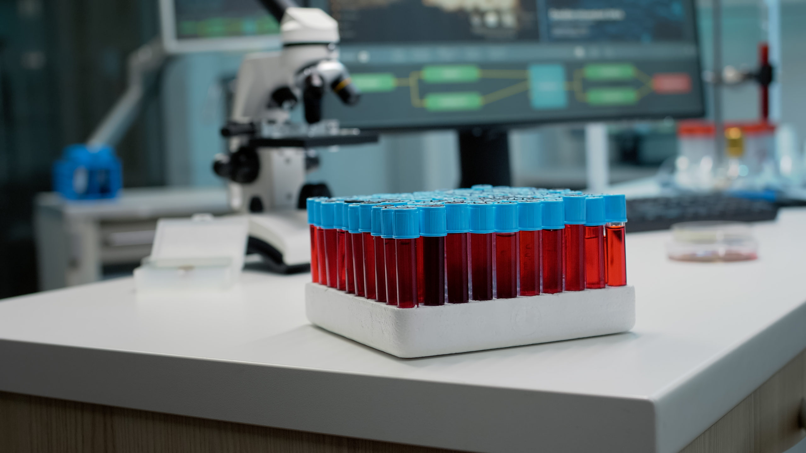 Close up of vacutainers with blood or red liquid in laboratory